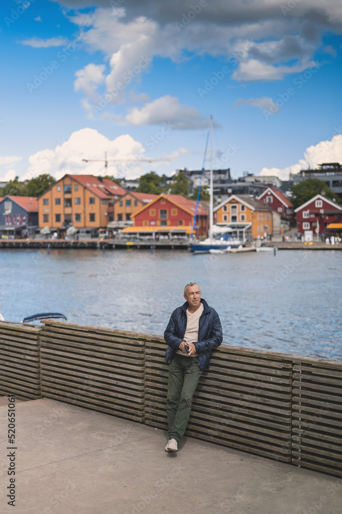 Fototapeta premium attractive old man walking in the city lifestyle portrait with Tonsberg viewpoint