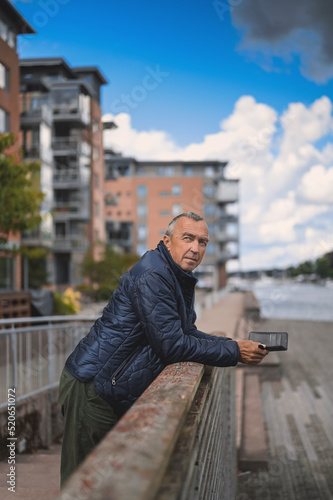 attractive old man walking in the city  lifestyle portrait with Tonsberg viewpoint