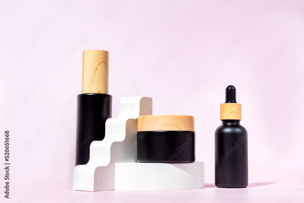 Fece serum in dropper bottle, essential oil, essence or lotion and face cream jar collection. beauty cosmetic skincare packaging design on trendy concrete podium with harsh light on pink background Fece serum in dropper bottle, essential oil, essence or lotion and face cream jar collection. beauty cosmetic skincare packaging design on trendy concrete podium with harsh light on pink background