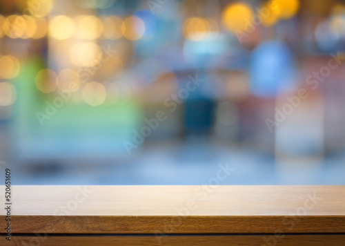 Art Empty wooden deck table over blurred fashion boutique background.
