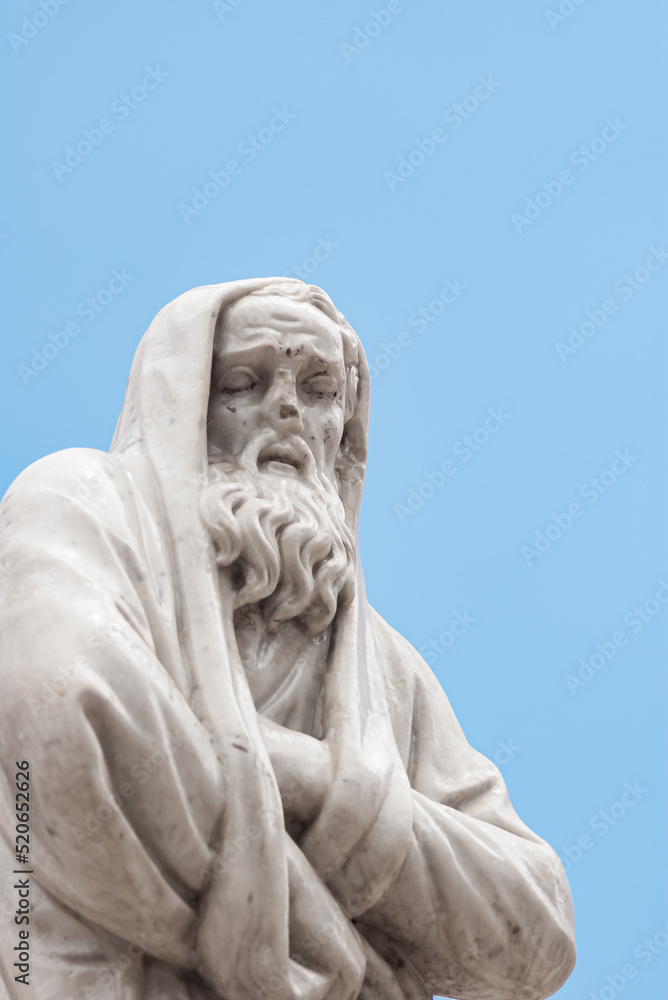 marble sculpture - a man with a beard in a cape, waist up