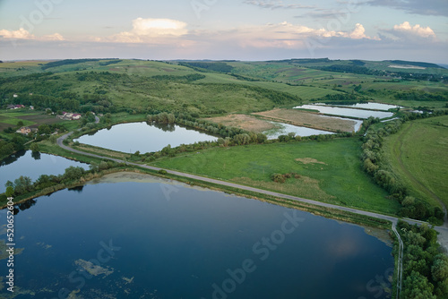 Фотография Aerial view of fish hetching pond with blue water in aquacultural area