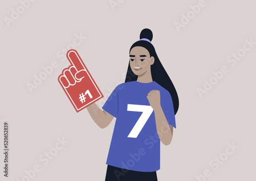 A young female Asian team supporter waving a foam finger, sports competition