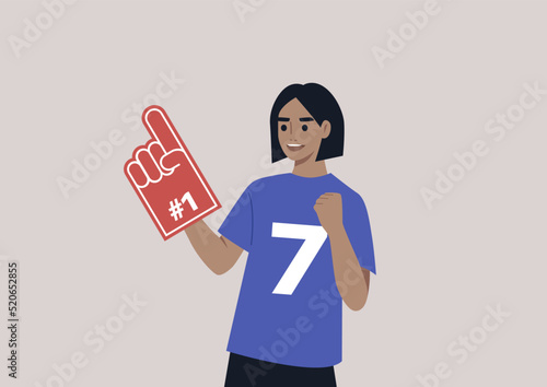 A young female Caucasian team supporter waving a foam finger, sports competition