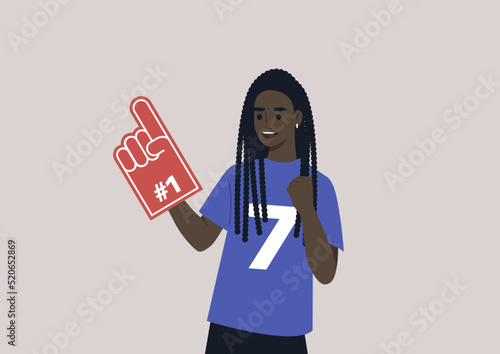 A young female African team supporter waving a foam finger, sports competition