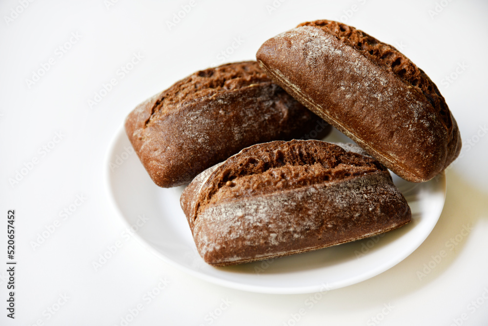 Rye bread from a hypermarket on a white plate. Delicious and beautiful bread macrophoto.