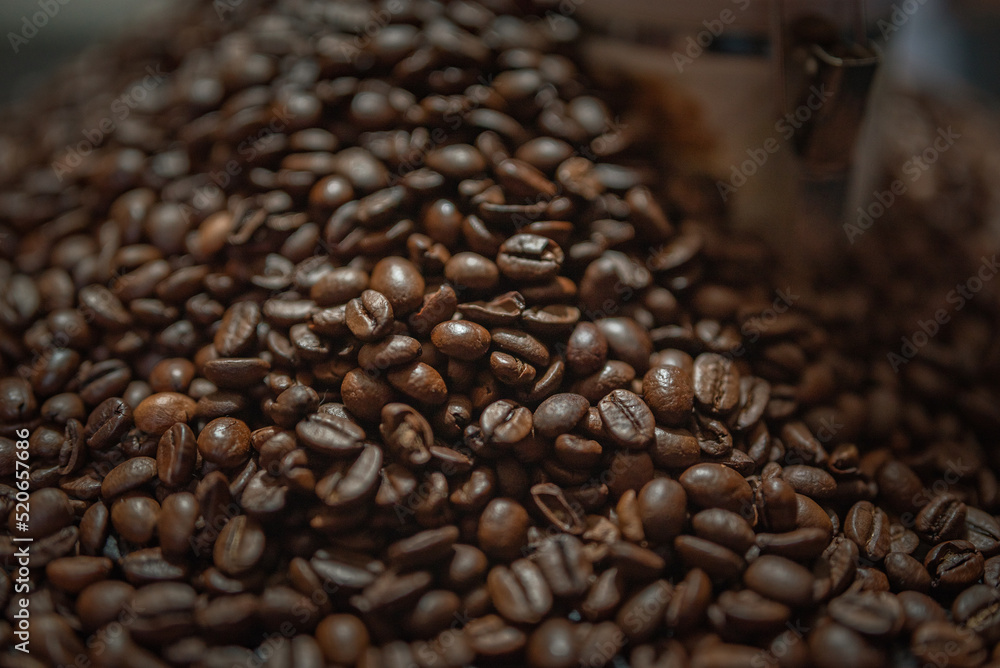 Fototapeta premium Grains of delicious roasted coffee in a manual mechanical coffee grinder.