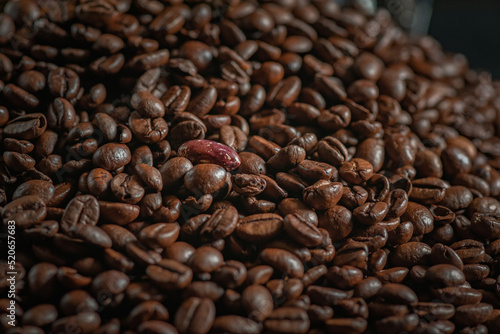 Grains of delicious roasted coffee in a manual mechanical coffee grinder.