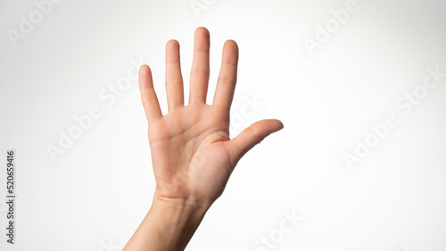 Women's hands gesture counting on fingers five palm side