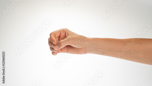 Hand woman gesture fingers clenched into a ring holding a cylindrical object
