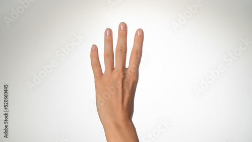 Women's hands count on fingers four back of palms