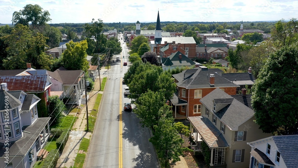 Fototapeta premium Neighborhood homes on main street in Charles Town, West Virginia, WV on a beautiful sunny day.