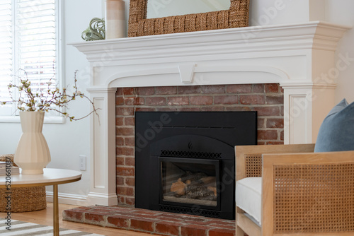 Fototapeta Original brick fireplace with new painted mantle and fireside seating