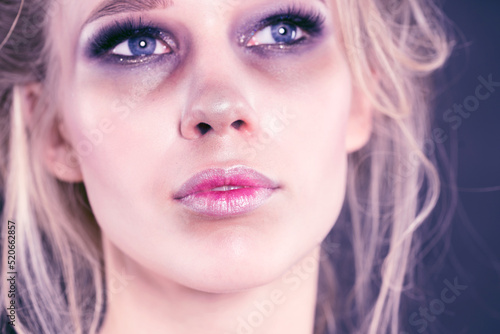 Sad girl with ugly makeup close-up.