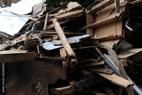 Debris and wooden remains and garbage pile on a stack on demolition site of a building