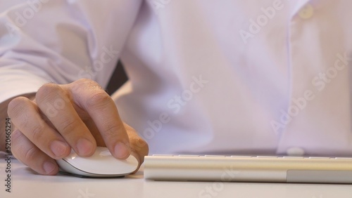 Hands typing on the keyboard. Male hands or man office worker typing on the keyboard