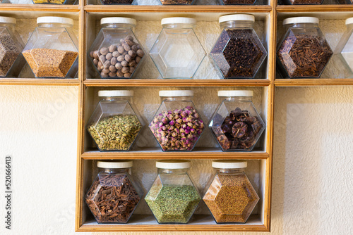 Many different colorful glass recipients in a row with different spices clours in a shop in Marrakesh photo