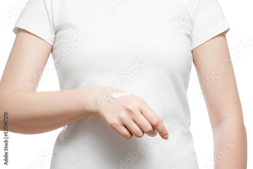 Wallpaper Mural Cropped shot of a woman in white t-shirt applying hand cream, isolated on white. Well-groomed short natural nails. Torontodigital.ca