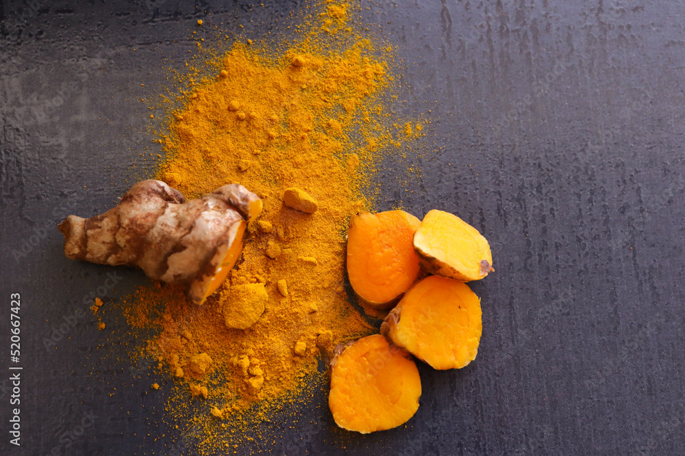 spices in a bowl. Whole and powdered turmeric spices in a bowl. Whole and powdered turmeric