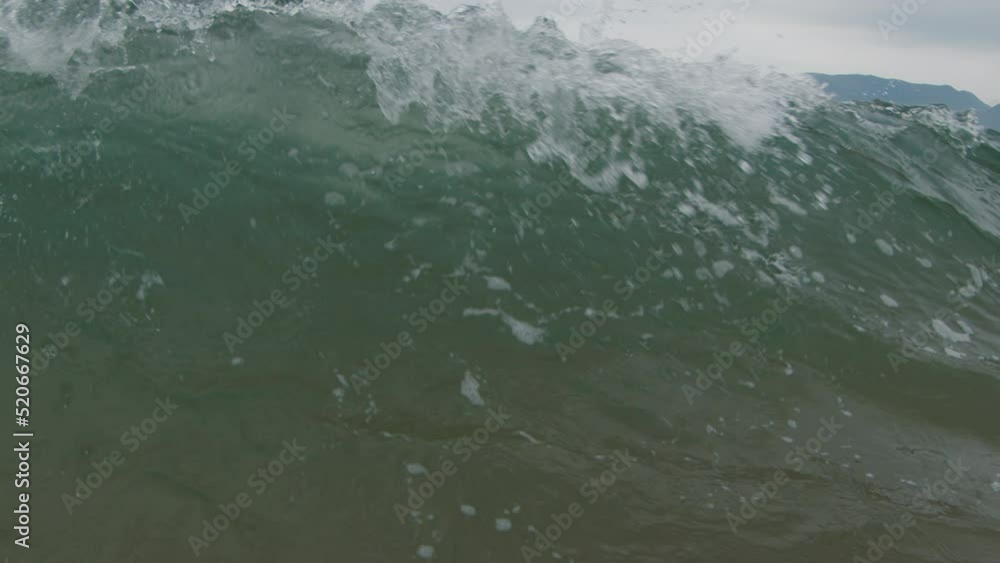 Murky ocean wave breaks on the Brazilian shore Murky ocean wave breaks on the Brazilian shore
