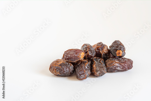 Date fruits on white wooden background with copy space.