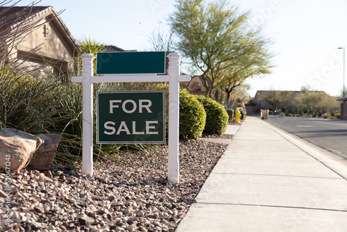 Real Estate: For Sale realtor sign in front of family house in expansive yard for real estate opportunity