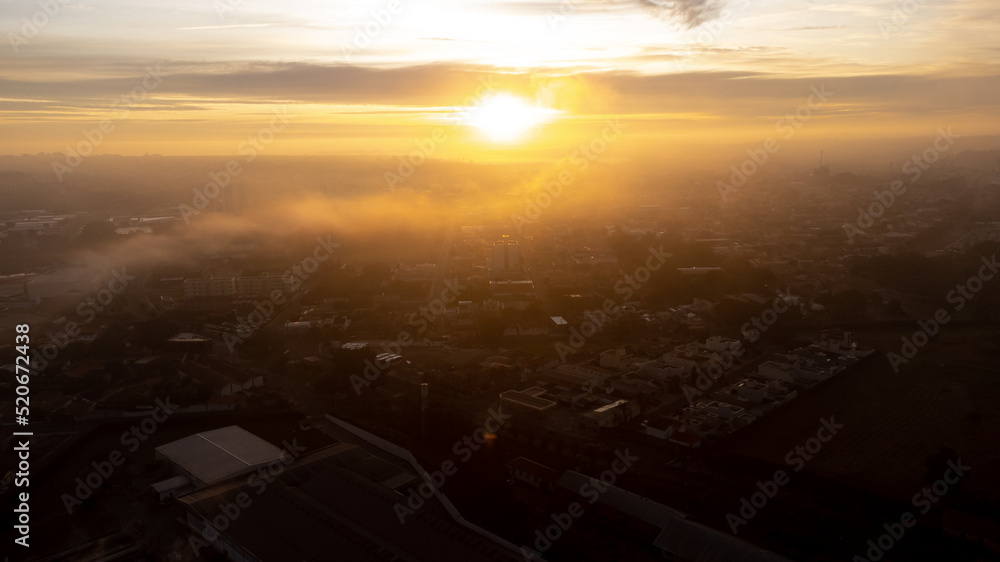 Sunrise, beautiful sunrise on a cold foggy morning in a small town in Brazil, drone photo.