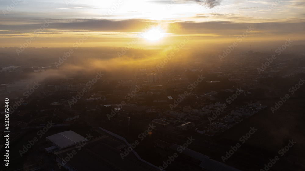 Sunrise, beautiful sunrise on a cold foggy morning in a small town in Brazil, drone photo.