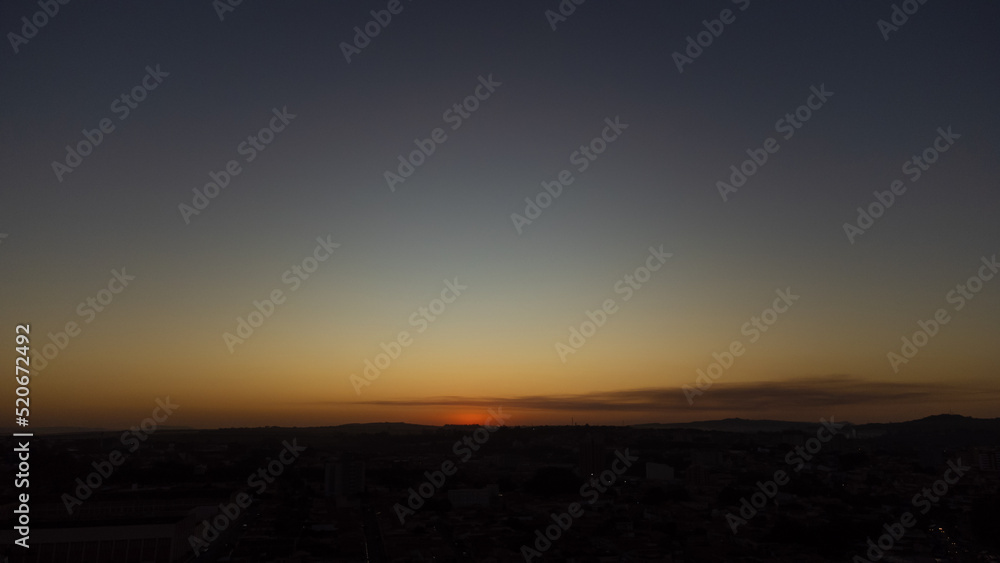 Sunset, beautiful sunset over a small town in Brazil, drone photo. Sunset, beautiful sunset over a small town in Brazil, drone photo.