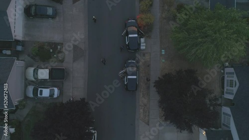 Aerial shot of police men and women outside their vehicles