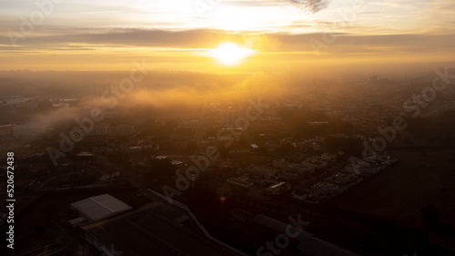 Sunrise  beautiful sunrise on a cold foggy morning in a small town in Brazil  drone photo.