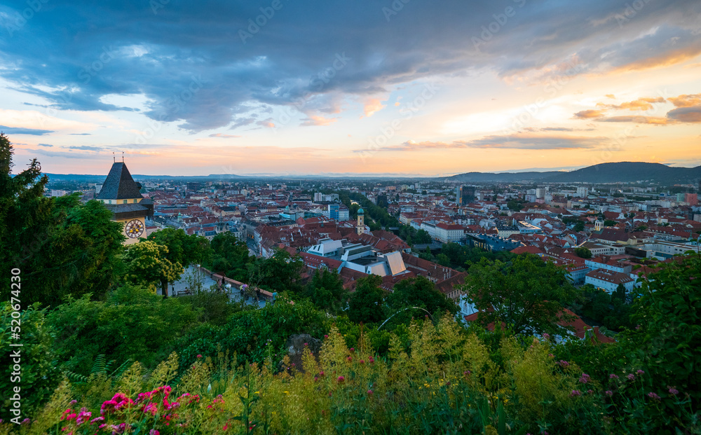 City of Graz, Austria and famous Uhrturm at sunset