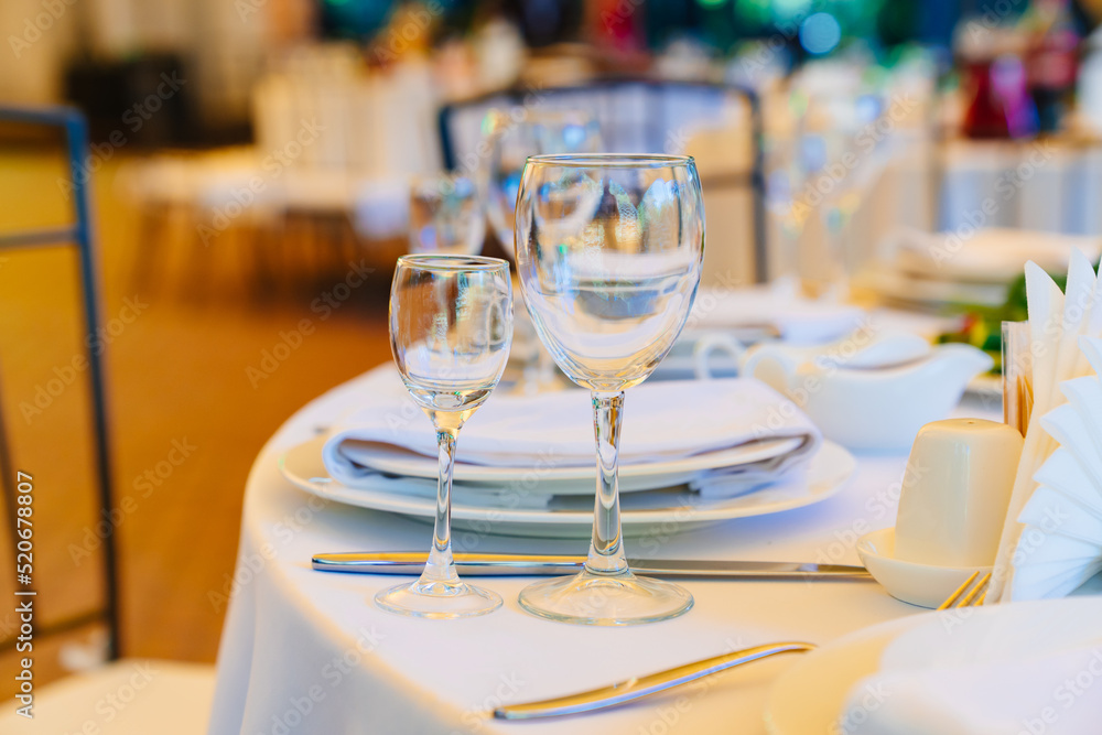empty wine glasses on a round table with a white tablecloth. empty wine glasses on a round table with a white tablecloth.