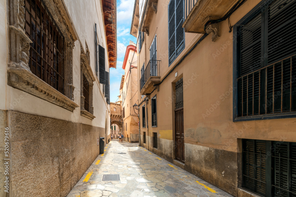 A traditional narrow alley in the Jewish Medieval Quarter of the Spanish city of Palma de Mallorca, on the Balearic Mediterranean island of Mallorca, Spain.