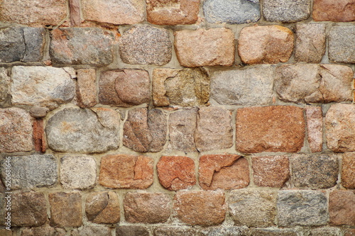 an old wall made of cobblestones and large stones of various shapes and colors