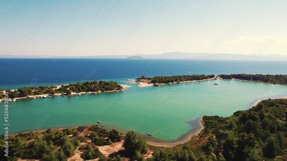 Aerial View of Glarokavos Port and Beach. Difference between water colour. Turquoise and dark blue. . High quality photo