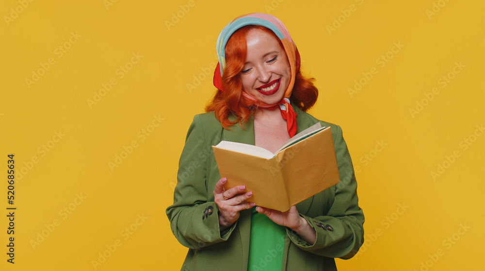 Redhead young woman reading funny interesting fairytale story book, leisure hobby, knowledge wisdom, education, learning, study, wow. Red hair ginger girl isolated alone on yellow studio background Redhead young woman reading funny interesting fairytale story book, leisure hobby, knowledge wisdom, education, learning, study, wow. Red hair ginger girl isolated alone on yellow studio background