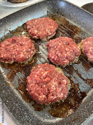 Red hamburger cutlets fry in a frying pan