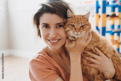 Canvas Print Portrait of caucasian woman smiling and hug her cat while taking rest at home