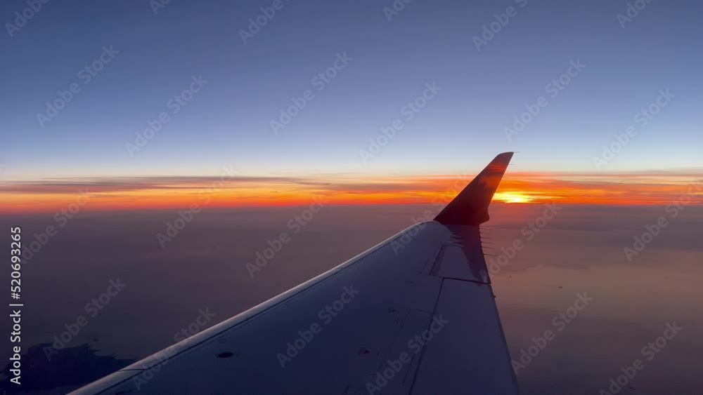Beautiful sunset view from a jet with the view of the right wing and winglet while crossing the English Channel at 10000 metres high. Beautiful sunset view from a jet with the view of the right wing and winglet while crossing the English Channel at 10000 metres high.