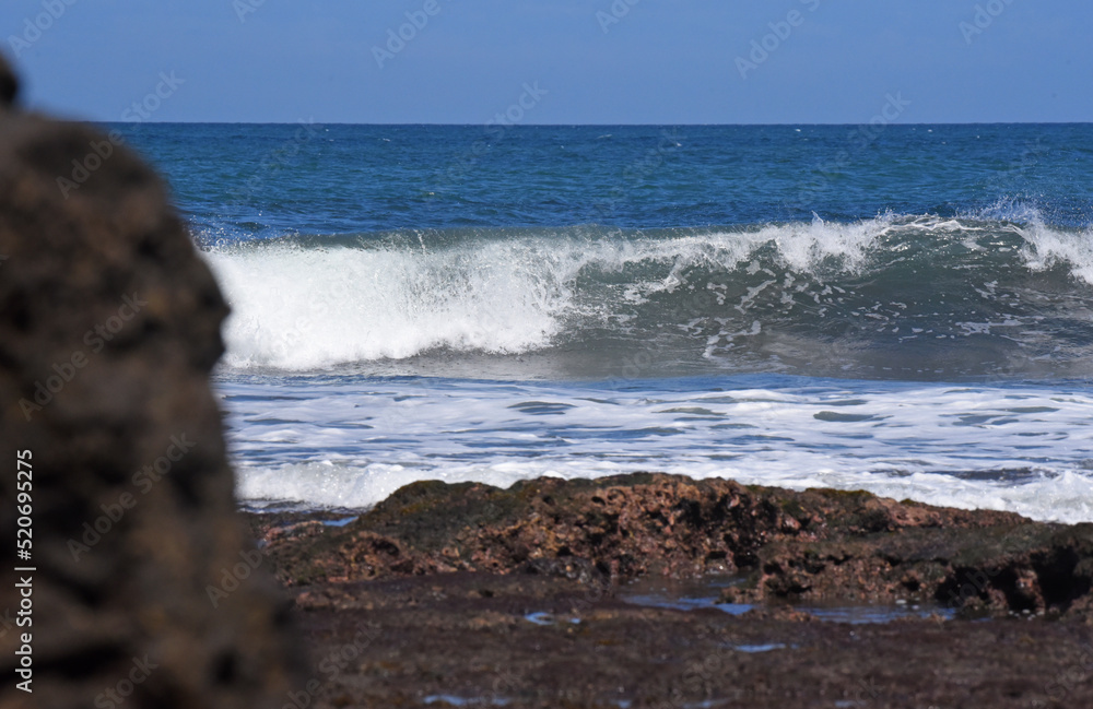 Seascapes at south cost in Bali island of Indonesia,with rock formation and big wave