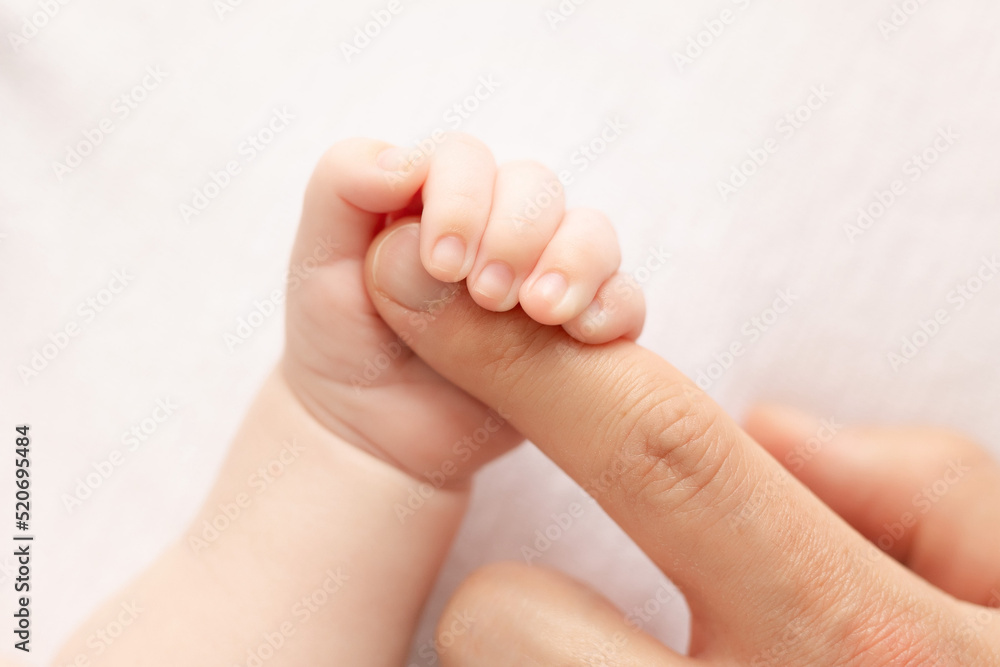 Little baby hand holding father`s finger Little baby hand holding father`s finger