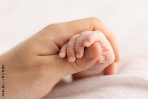 father hand holding baby`s hand