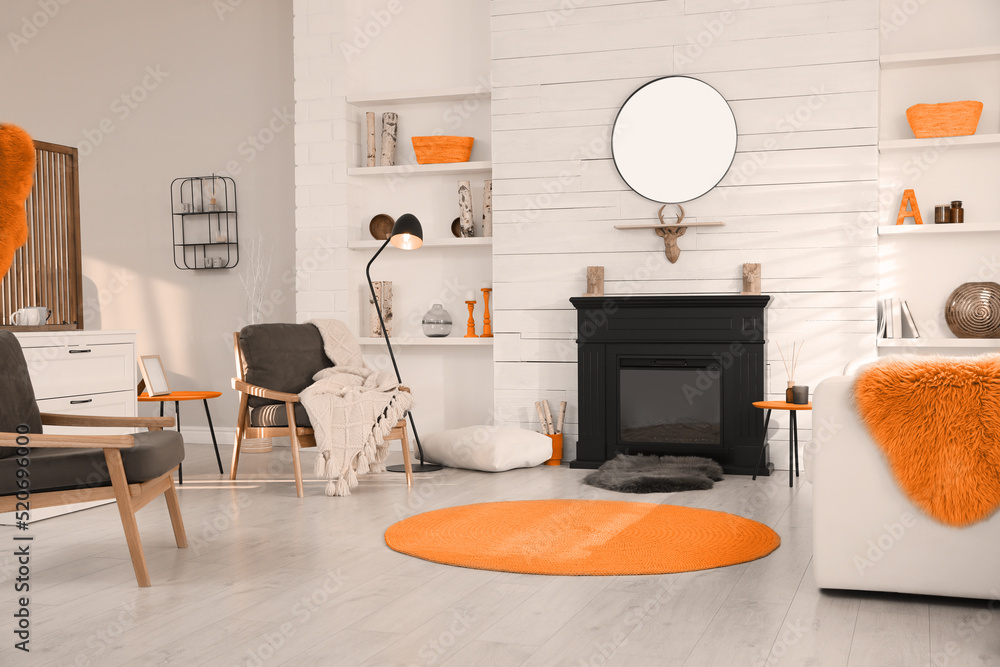 Obraz premium Cozy living room interior with comfortable furniture and modern electric fireplace