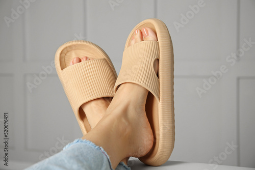 Woman wearing comfortable rubber slippers indoors, closeup