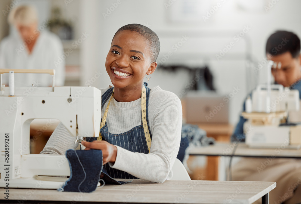 Happy, creative black fashion student or designer sitting and smiling