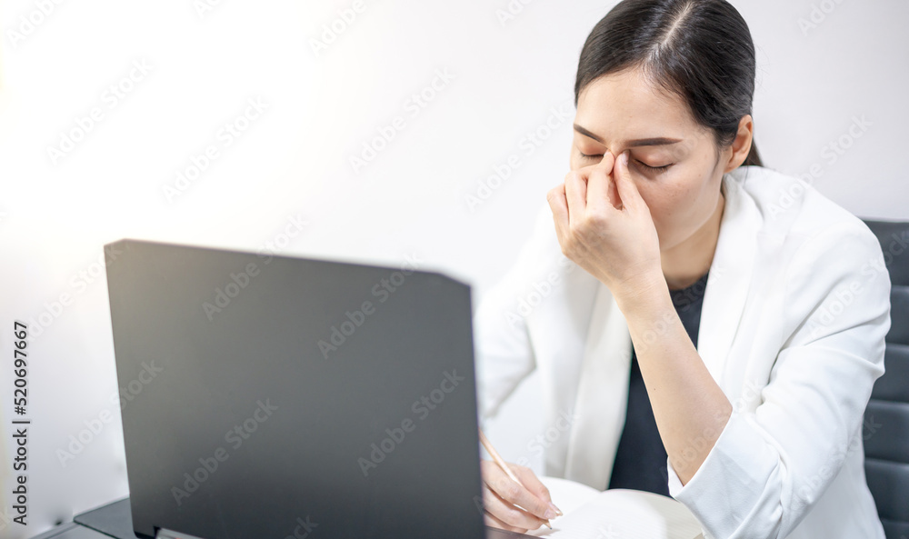 Asian young feeling stress from work, while sitting in front of the laptop in their home. Asian young feeling stress from work, while sitting in front of the laptop in their home.