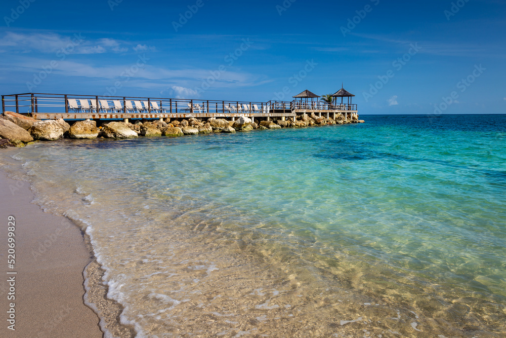 Tropical paradise: caribbean beach with pier and gazebo, Montego Bay, Jamaica