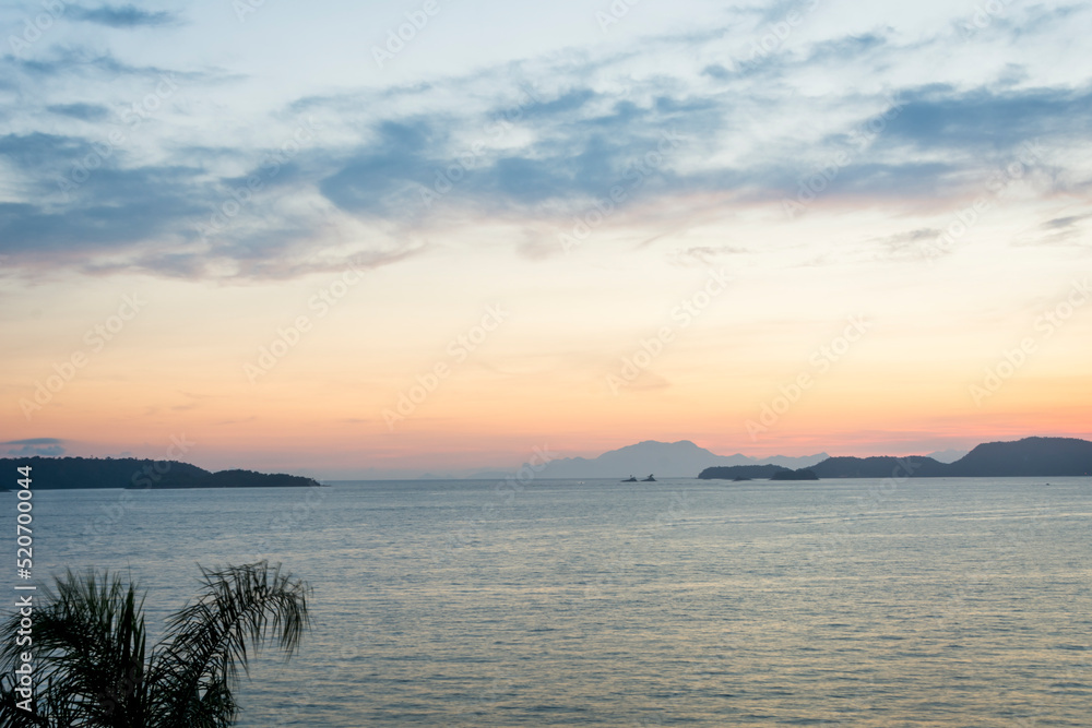 Fototapeta premium Sunset over the sea at the coast of Angra dos Reis town, State of Rio de Janeiro, Brazil. Photo taken with Nikon D7100, 18-200 lens, at 32mm, 0.6 sec f 11.0 ISO 100. Date: Dec 28, 2016