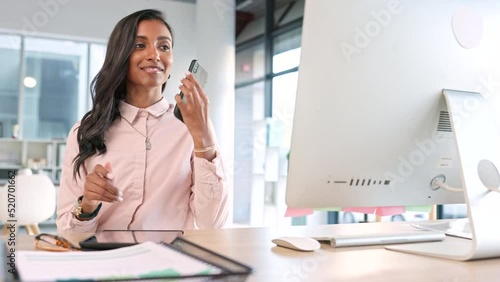 Business woman answering a phone call while browsing online, sending emails or planning a strategy in an office alone at work. Intern or corporate professional having a conversation and networking